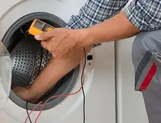 Washing machine repair technician testing a front-load washer with diagnostic tools in Cambridge, MA